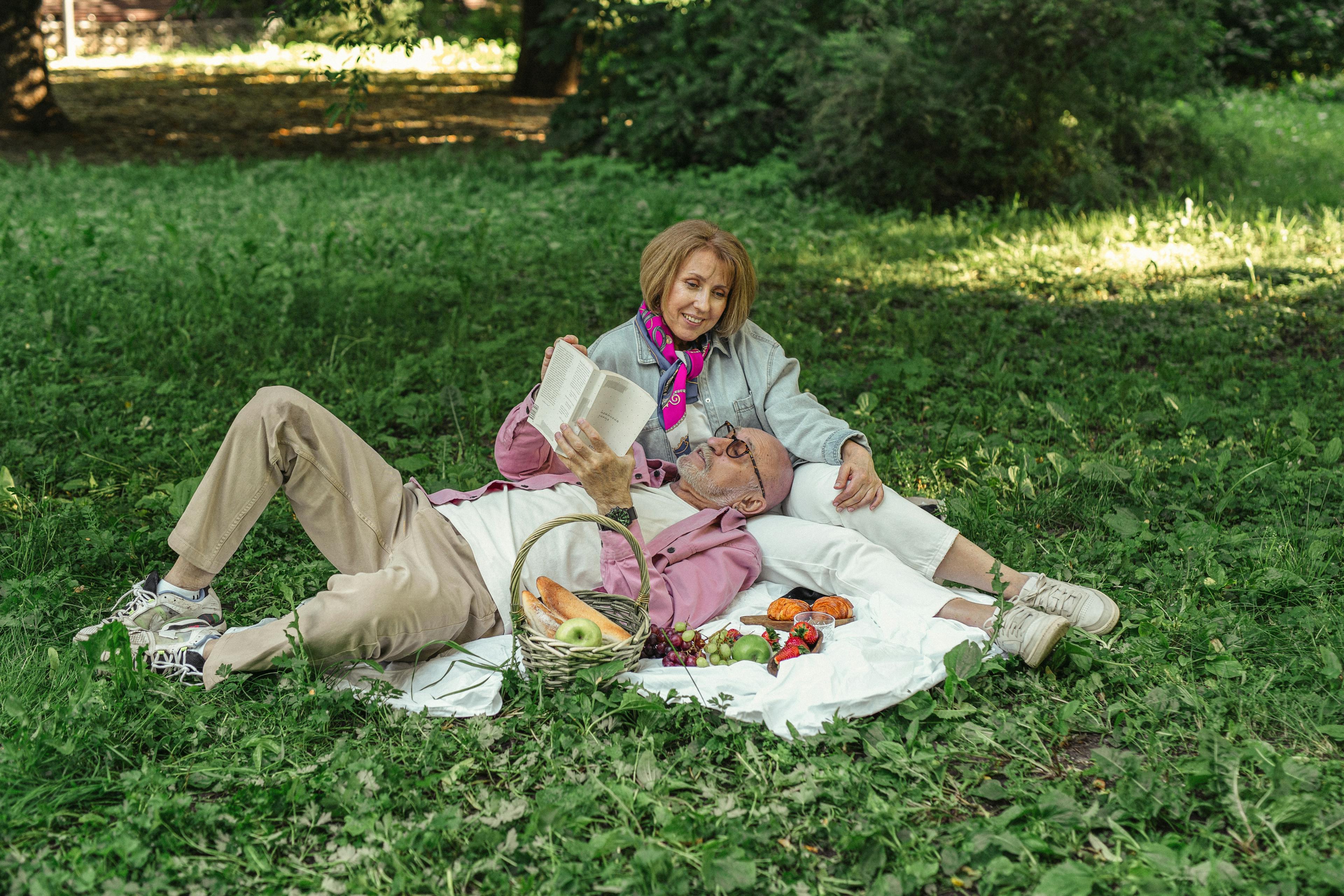 Older couple reading having picnic