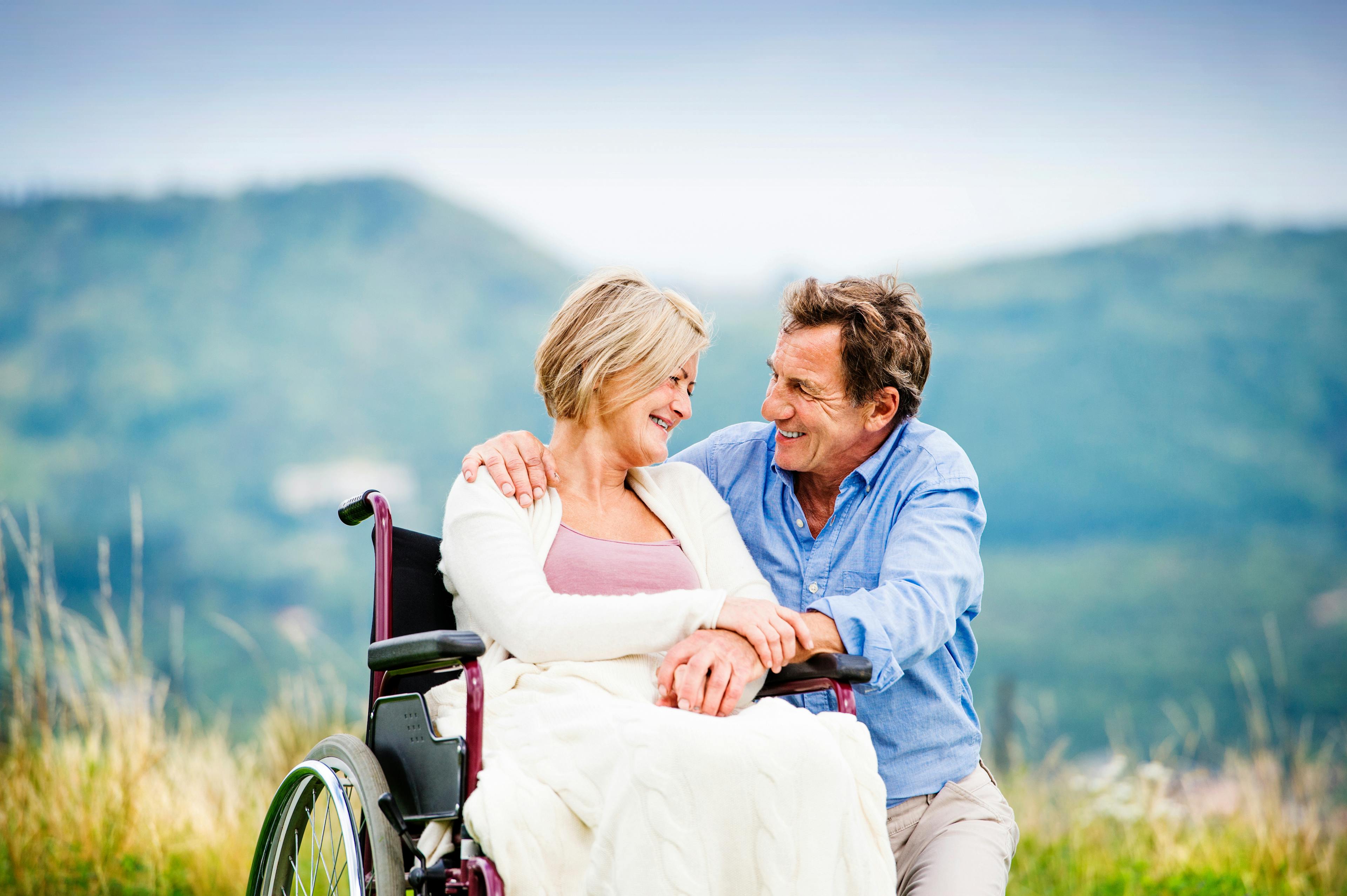 Man with woman sitting in wheelchair