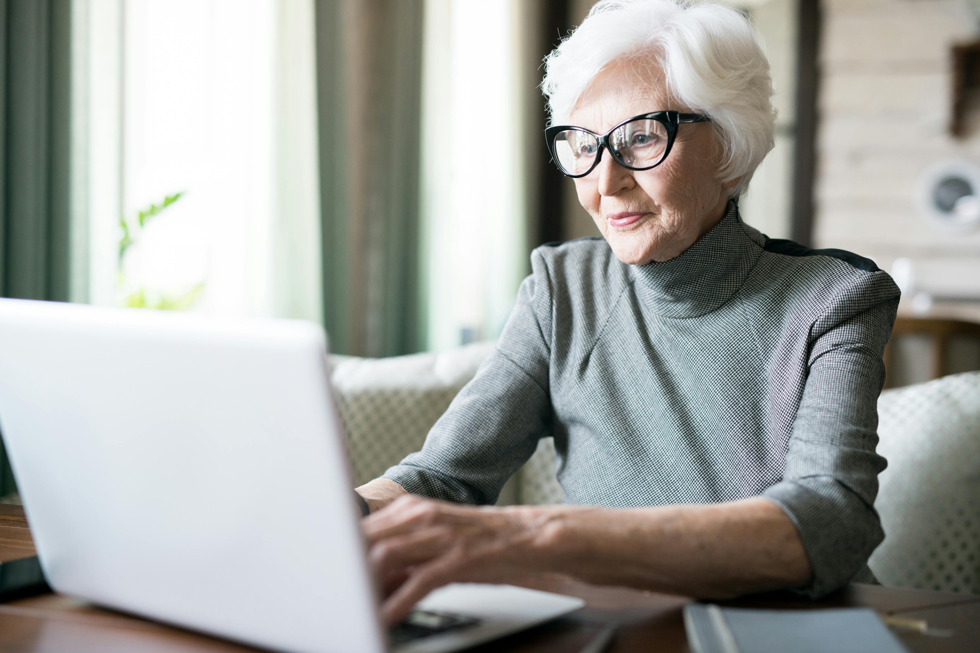 Senior woman white hair on laptop