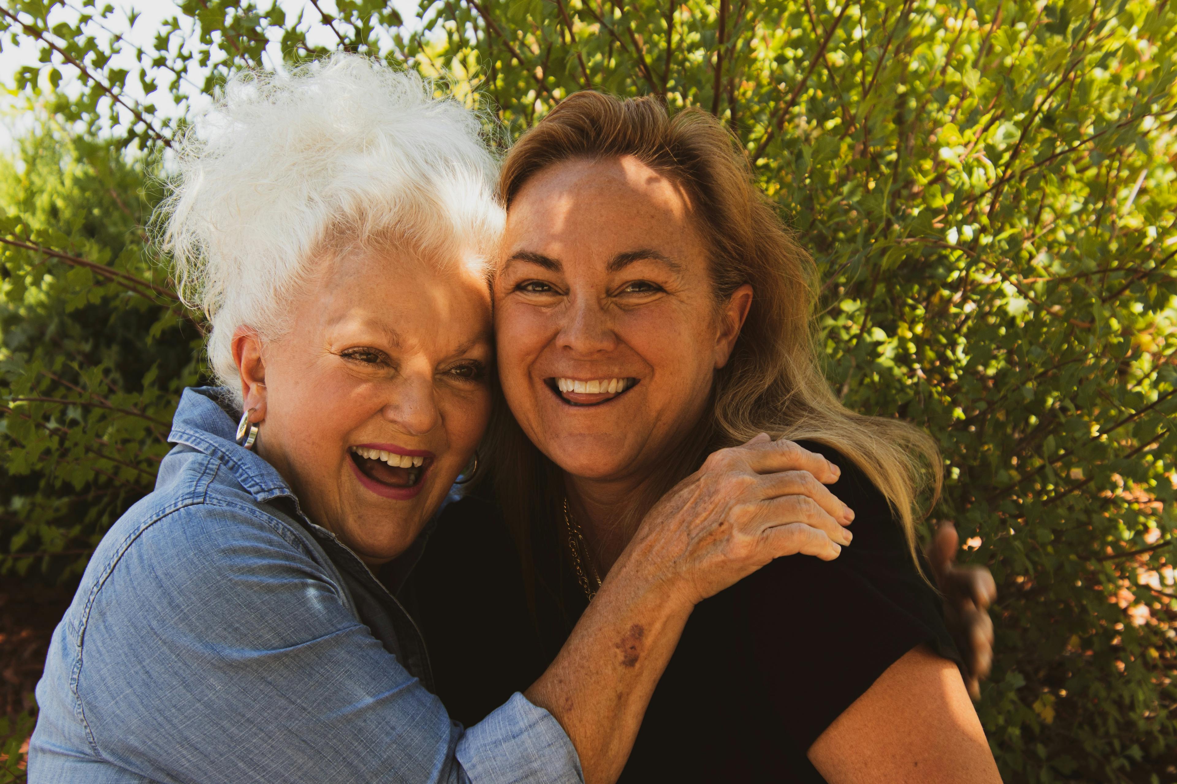 Women hugging and laughing.