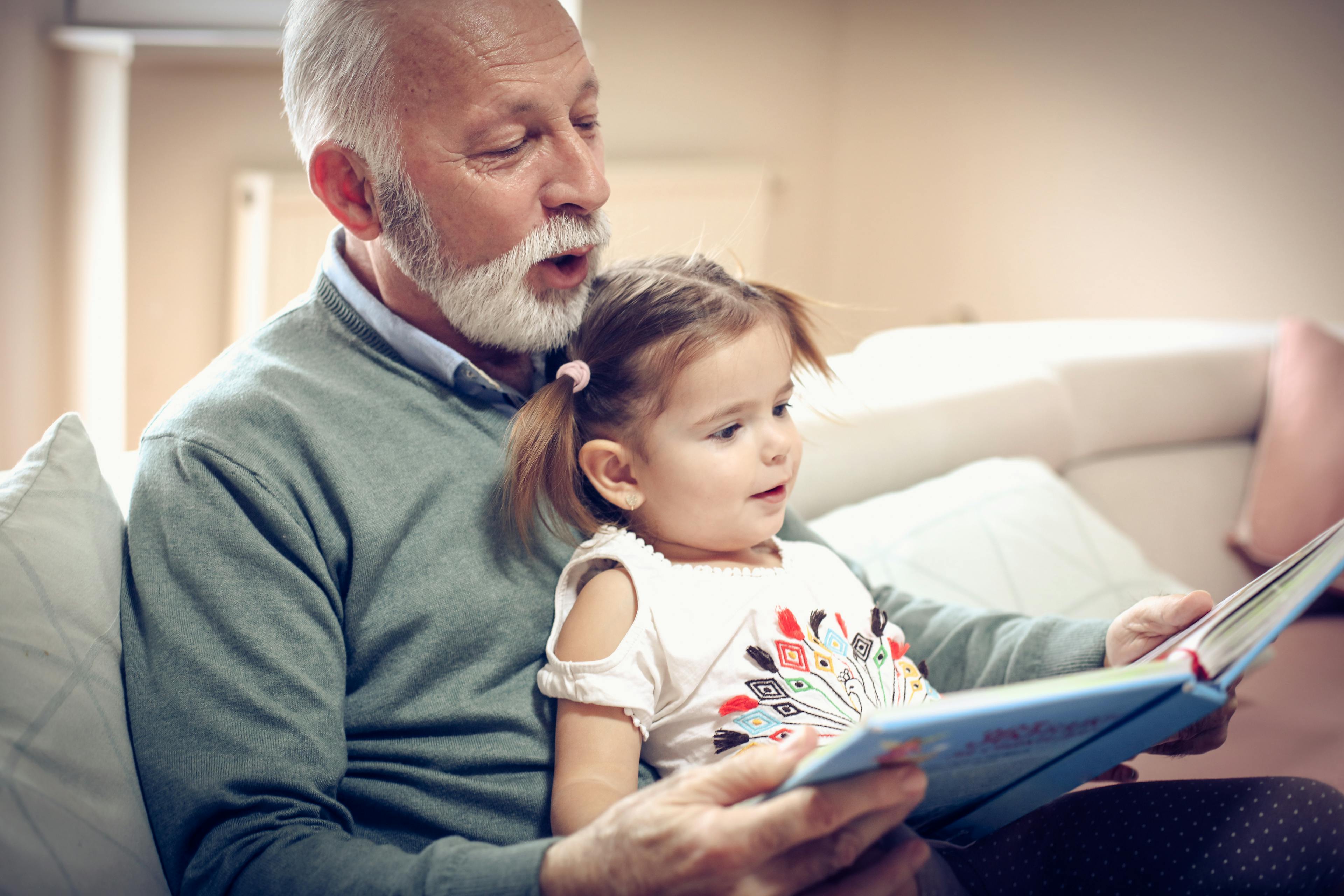 Man reads to granddaughter