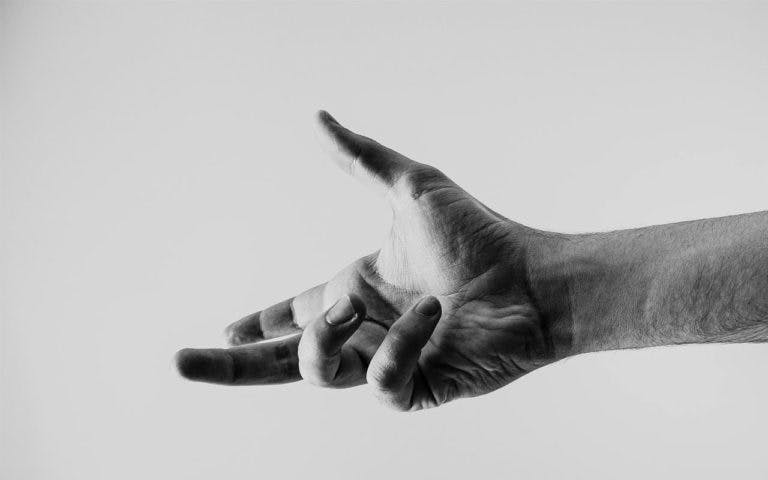 Black and white photo of hand reaching out
