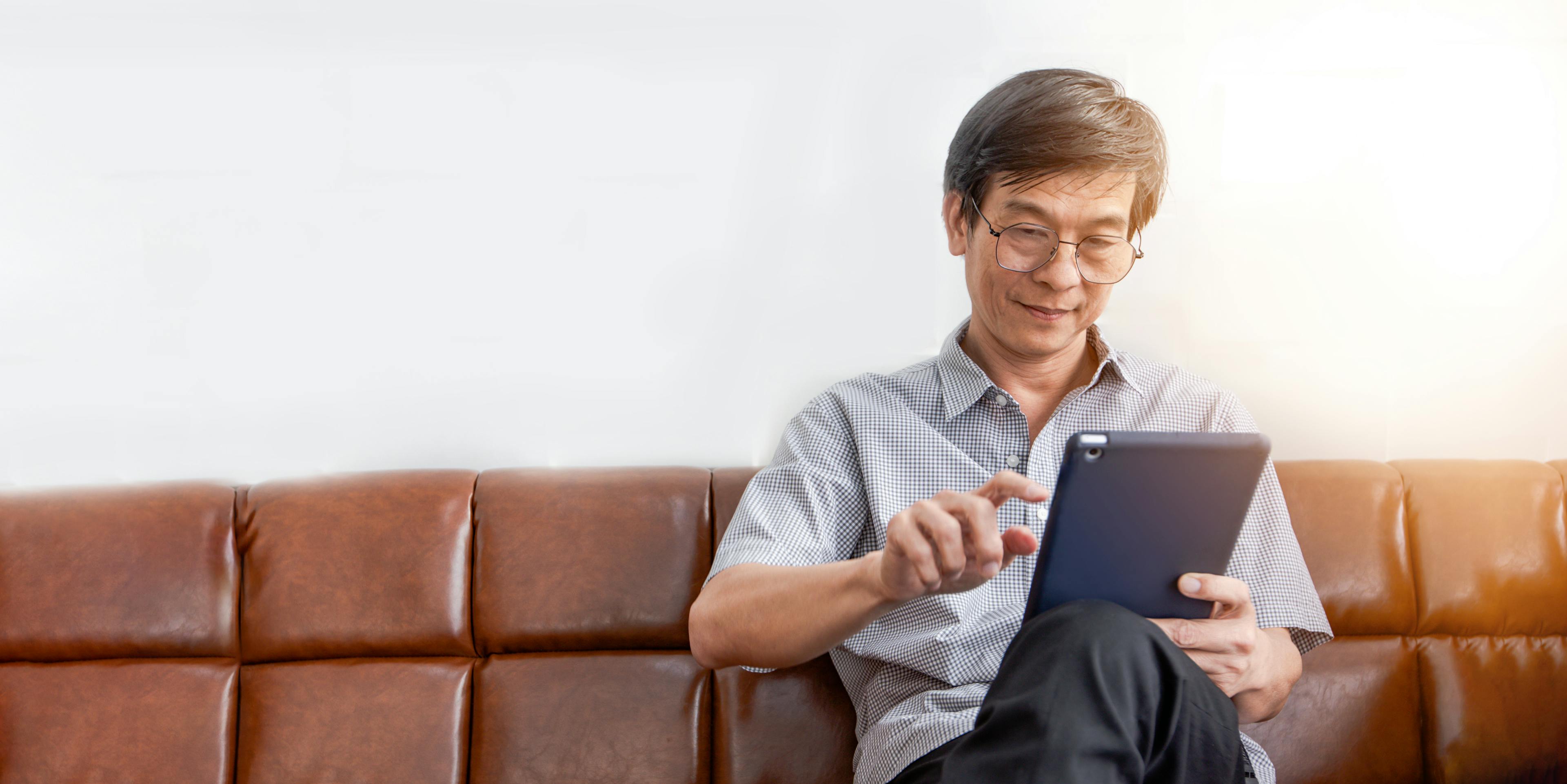 Man looking at tablet.