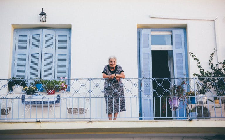 Older women on balcony leaning on railing