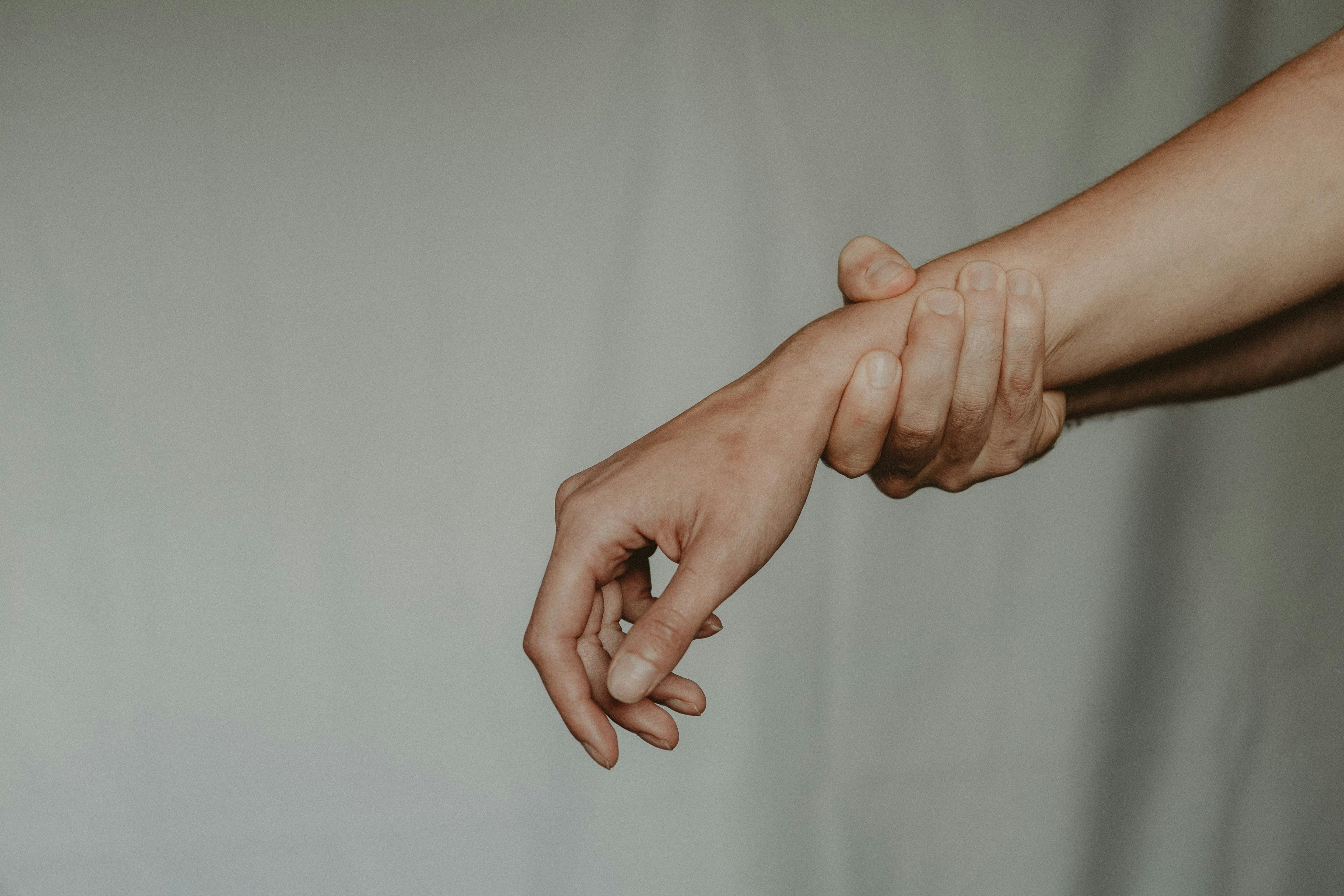 Person grabbing their wrist.