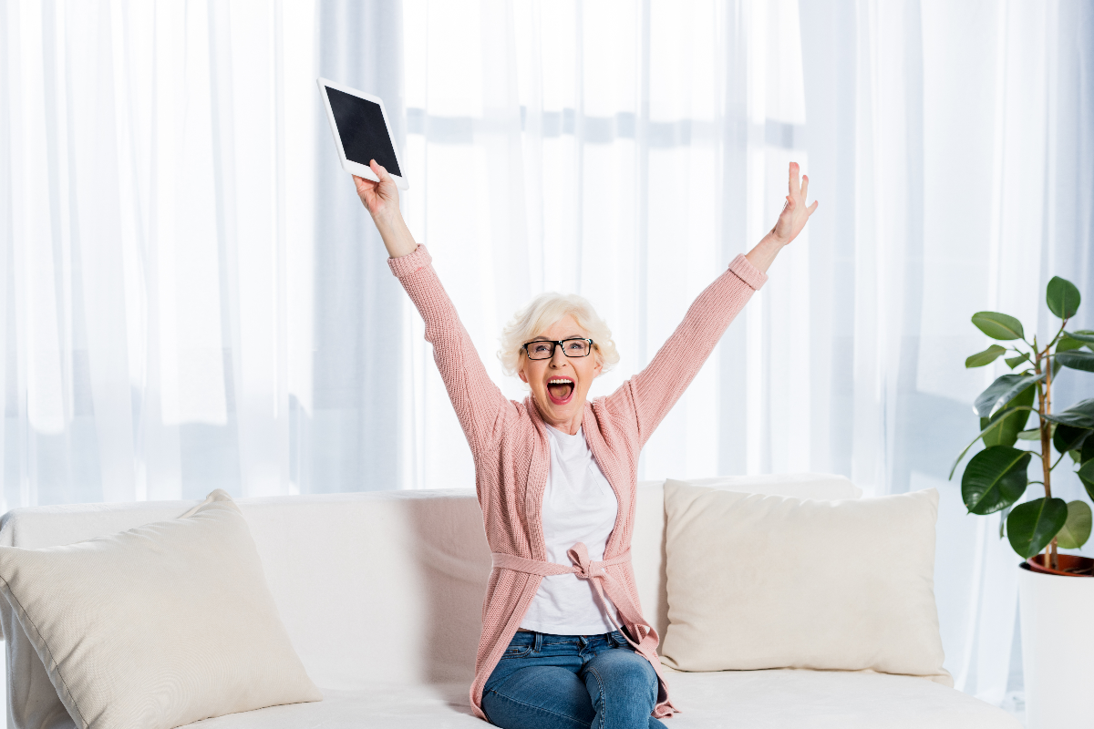 Woman with tablet cheering.